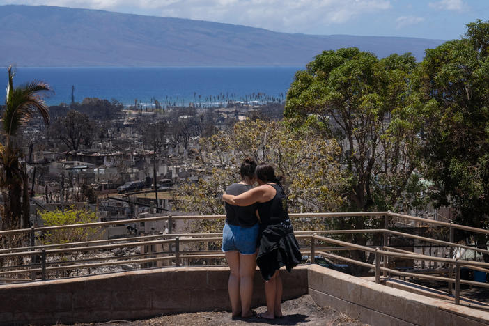 Two women embrace and cry as they look out over Lahaina, in Maui, Hawaii, which was severely damaged by a wildfire in August.