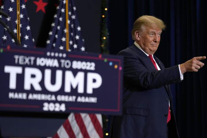 Former President Donald Trump greets supporters as he arrives at a rally on Tuesday in Waterloo, Iowa.