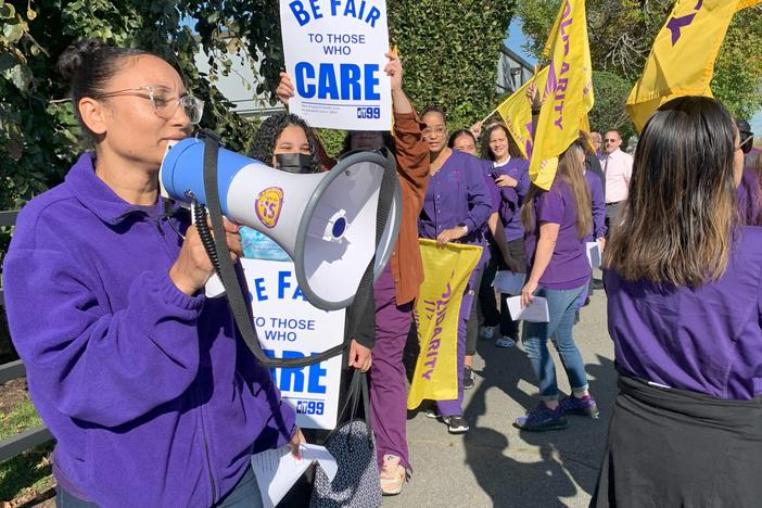 Unionized workers picket outside the Providence Community Health Centers on Oct. 12, 2023.