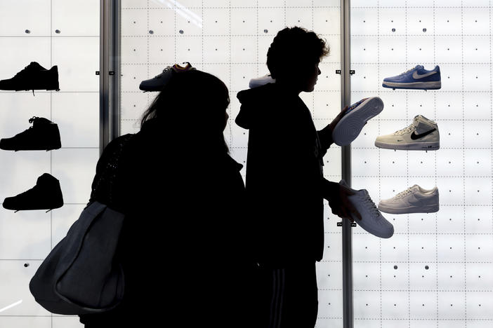People shop for Nike shoes at a store in New York.