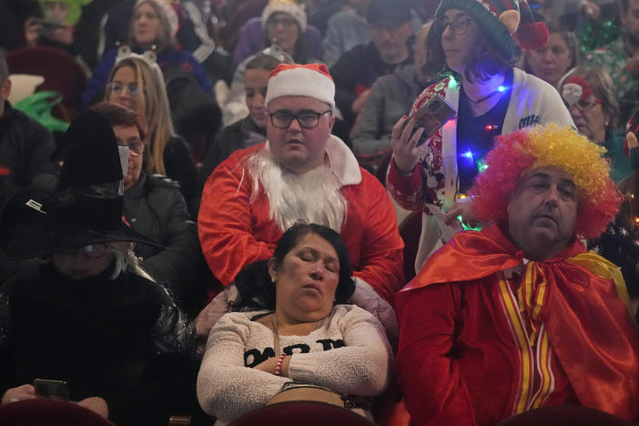 People wait for the start of the draw at Madrid's Teatro Real opera house during Spain's bumper Christmas lottery draw known as El Gordo, or The Fat One, in Madrid, Spain, Friday, Dec. 22, 2023.