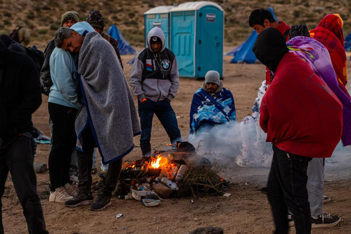 Migrants huddling for warmth at an unofficial detention camp in Jacumba, Calif. A record number of people have arrived at the southern U.S. border in the past year.