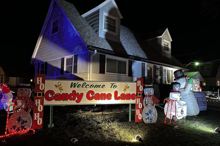 A sign greets visitors near Candy Cane Lane's entrance. About 300 homes in the Milwaukee-area neighborhood display decorations to benefit children's cancer research.
