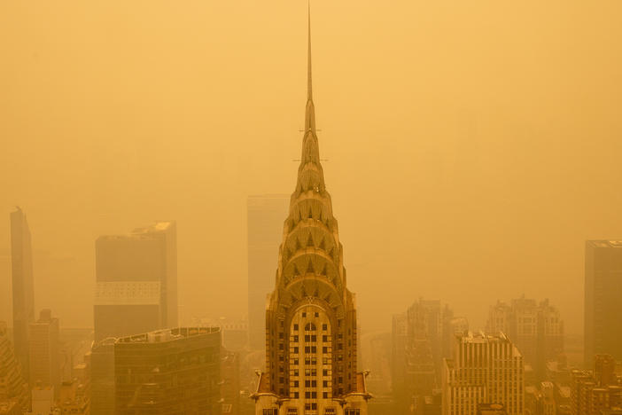 Smoke from wildfires turned the skies orange behind New York's Chrysler Building in June 2023. The smoke affected millions across the central and eastern U.S.