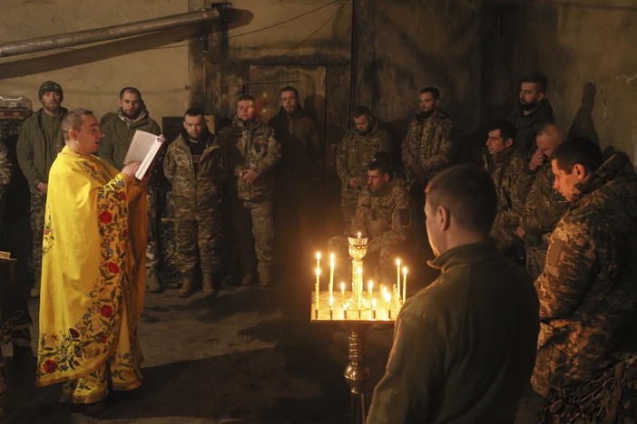 A clergyman with the Orthodox Church of Ukraine, Chaplain Ivan, conducts a liturgy for Ukrainian troops near the front line in the eastern town of Vuhledar on Dec. 15.