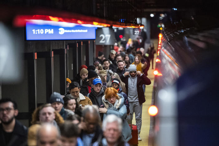 Travelers walk the ramp as they arrive to Grand Central Station in New York, Thursday, Dec. 21, 2023.
