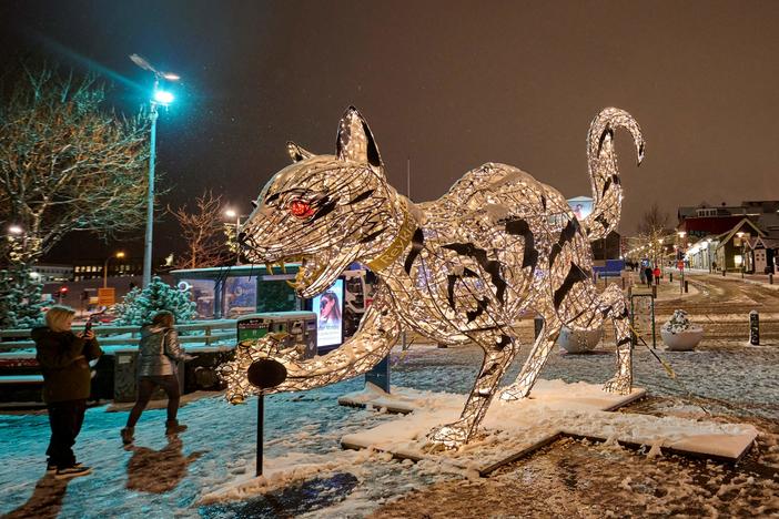 An illuminated cat sculpture in downtown Reykjavik on November 29, 2021. Icelandic folklore tells of a giant cat that eats children who don't wear their new clothes at Christmas time.