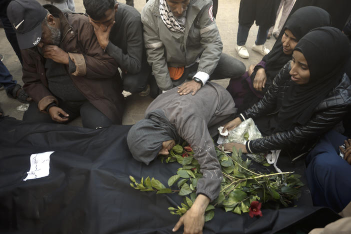 Palestinians mourn relatives killed in the Israeli bombardment of the Gaza Strip outside a morgue in Khan Younis on Sunday, Dec. 24, 2023.