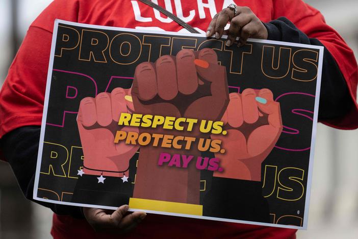 A person holds a sign at a rally to raise the federal minimum wage, on Capitol Hill in Washington, D.C., on May 4.