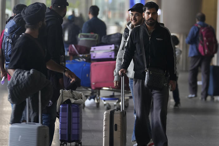 Indian passengers who travelled in an unmarked Legend Airlines A340 from Vatry Airport in France, arrive at the Chhatrapati Shivaji Maharaj International Airport in Mumbai, India, Tuesday, Dec. 26, 2023.