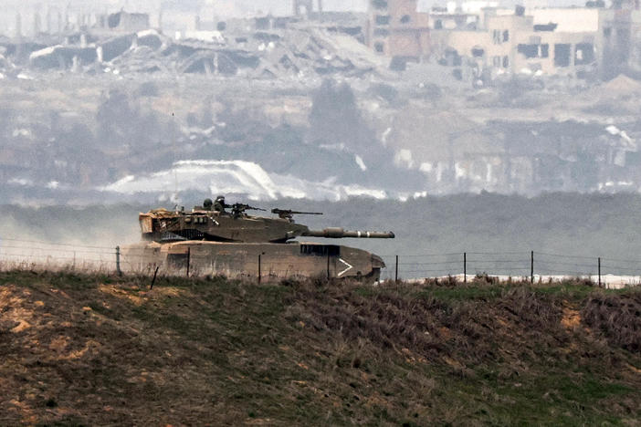 An Israeli battle tank moves along the border between the Gaza Strip and southern Israel on Wednesday as battles between Israel and Hamas continue.