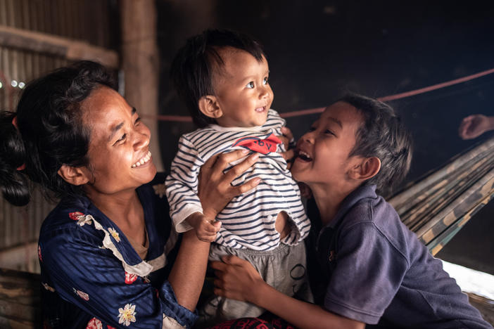 Ten-month-old Ahmin Esas, who was born with clubfoot, shares a moment with his mother and brother in the family's home near Battambang, Cambodia. As a single parent with limited means, his mother, Pho Sok overcame many challenges to ensure her son could receive the treatment he needed.