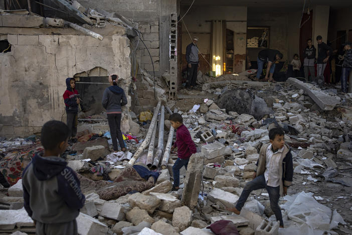Palestinians look at the destruction after an Israeli strike in Rafah, southern Gaza Strip, on Friday.