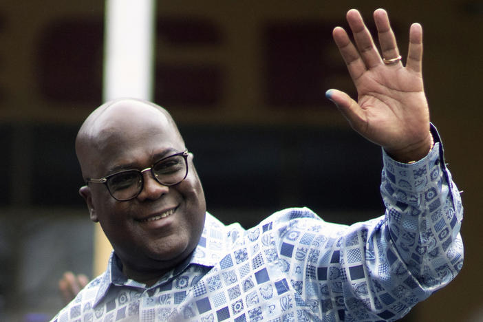 Congo's President Felix Tshisekedi waves to his supporters after casting his ballot inside a polling station during the presidential elections in Kinshasa, Democratic Republic of Congo, Wednesday, Dec. 20, 2023.