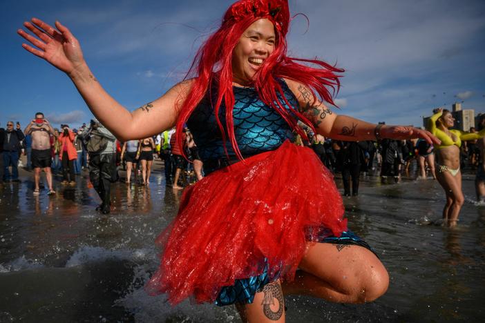 A mermaid takes the annual polar bear plunge at Brooklyn's Coney Island beach last year. More people take cold plunges on a regular basis for health benefits, but hype outpaces research for now.