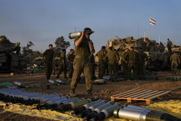 Israeli soldiers load shells onto a tank Sunday at a staging area in southern Israel near the border with Gaza. The army is battling Palestinian militants across Gaza in the war ignited by Hamas' Oct. 7 attack into Israel.
