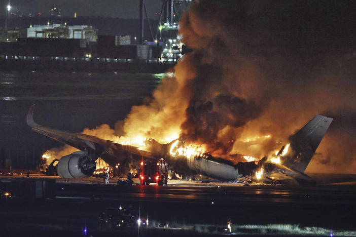 A Japan Airlines plane is on fire on the runway of Haneda airport on Tuesday in Tokyo.