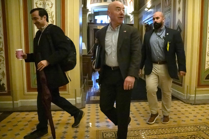 Homeland Security Secretary Alejandro Mayorkas, center, arrives at the U.S. Capitol on Dec. 17 for negotiations on a border security deal.
