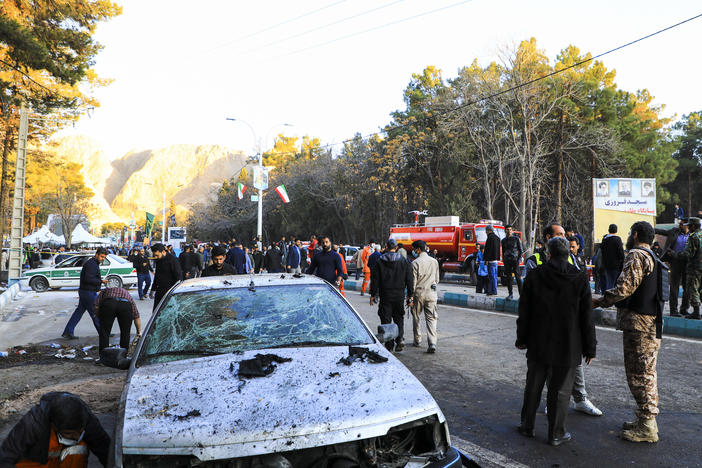 People gather at the site of an explosion in the city of Kerman, about 510 miles southeast of the capital Tehran, Iran, on Wednesday. Two bombs exploded at a commemoration for a prominent Iranian general slain by the U.S. in a 2020 drone strike, Iranian officials said.