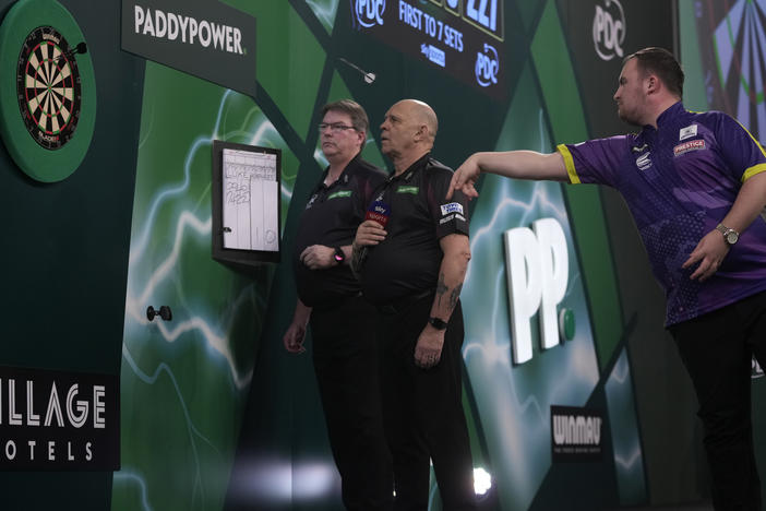 Luke Littler of England throws his dart during the final match against Luke Humphries of England at the World Darts Championship, in London, Wednesday.