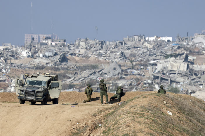 Israeli soldiers overlooking Gaza City on Monday.