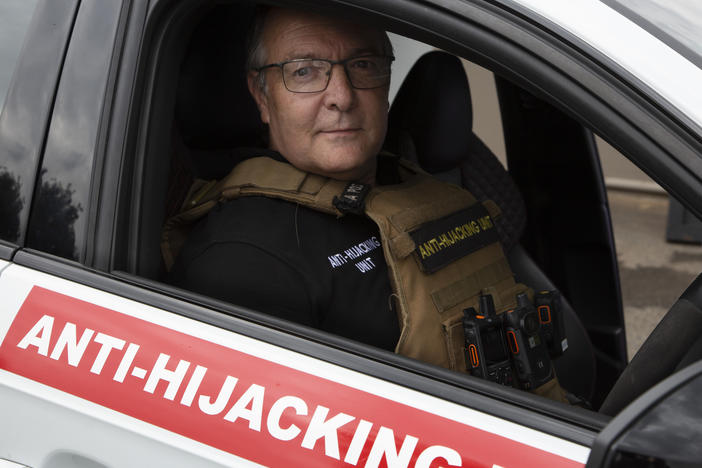 Anton Koen, a former police officer who now runs a private security firm that specializes in tracking and recovering hijacked and stolen vehicles, prepares to go out on patrol east of Johannesburg, South Africa, on Tuesday, Nov. 28, 2023.