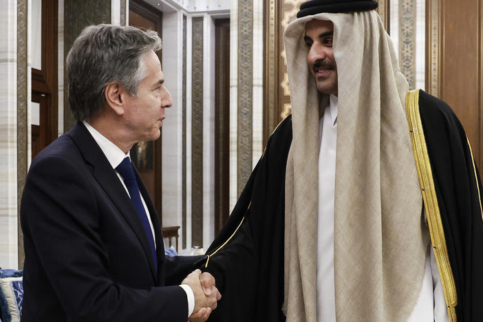 U.S. Secretary of State Antony Blinken, left, shakes hands with Qatar's Emir Sheikh Tamim Bin Hamad Al Thani, during Blinken's week-long trip aimed at calming tensions across the Middle East, at Lusail Palace in Lusail, Qatar, on Sunday.