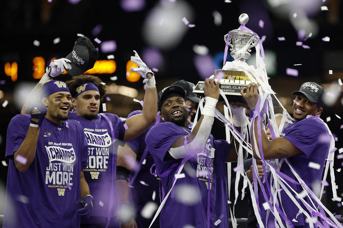 The Washington Huskies, seen here celebrating with the trophy after beating the Texas Longhorns in the Sugar Bowl in New Orleans, quickly rebuilt its roster by using transfers and players from out of state — particularly California.