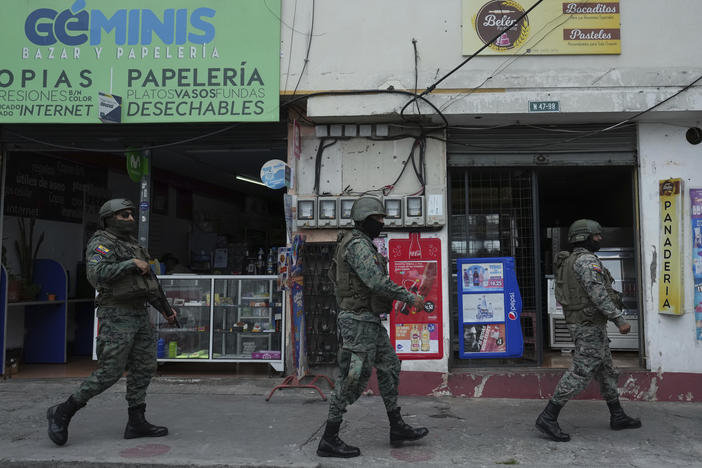 Soldiers patrol the perimeter of Inca prison during a state of emergency in Quito, Ecuador, on Tuesday in the wake of the apparent escape of a powerful gang leader from prison.