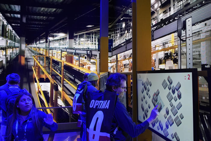 People play a pallet packing game at the Walmart booth during the CES tech show Tuesday, Jan. 9, 2024, in Las Vegas.