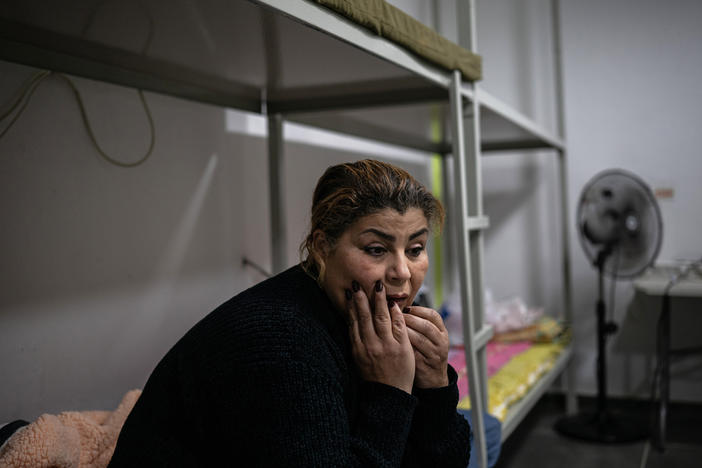 Sisilya al-Ousi sits in her apartment building's bomb shelter, where she spends most of her time.