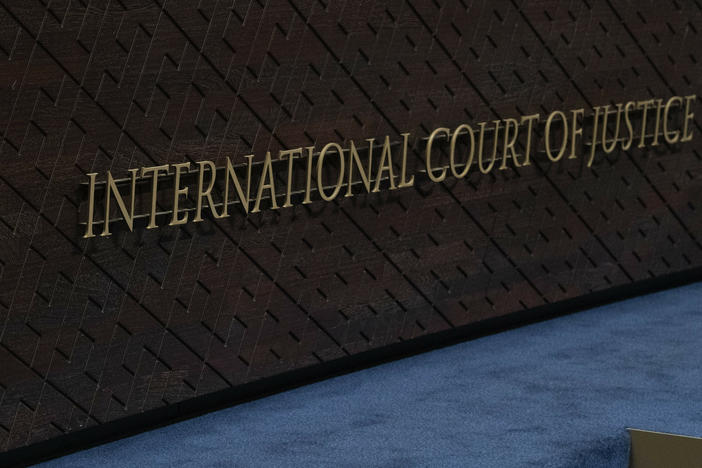 The logo of the International Court of Justice, left, and that of the U.N., right, are seen on the judges bench at the International Court of Justice, or World Court, in The Hague, Netherlands, Thursday, Oct. 12, 2023.