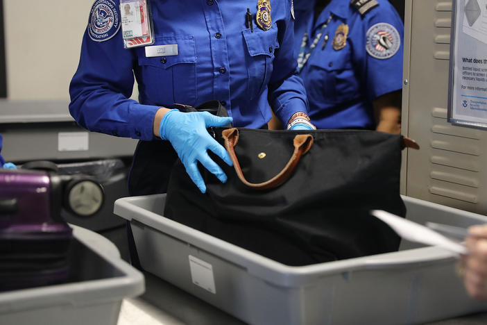 A Transportation Security Administration worker screens luggage at New York's LaGuardia Airport on Sept. 26, 2017. The TSA says it found a record number of firearms at airport security checkpoints last year.