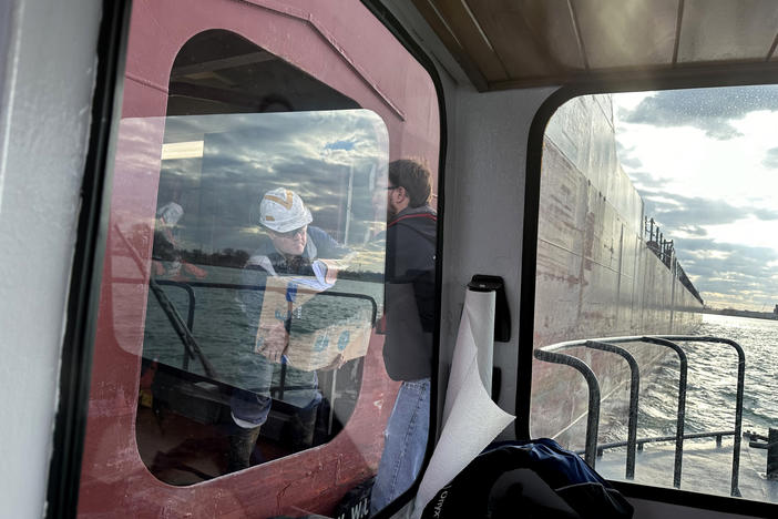 Sailors on the Great Republic, a Great Lakes bulk cargo carrier built in 1981, receive their mail on the Detroit River.