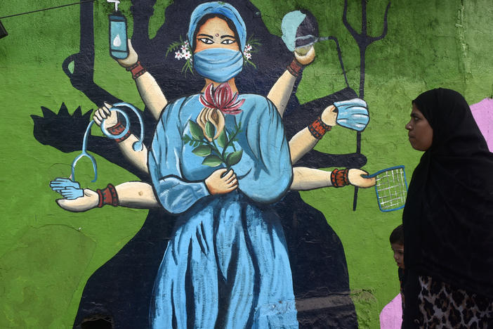 A street painting in Mumbai, India, reinforces the importance of masks amid a surge of COVID. The photo was taken on January 11.