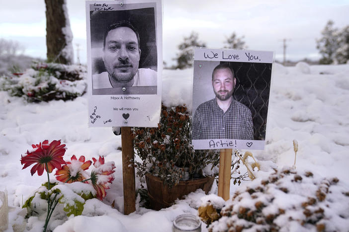 Pictures of two of the victims of the October 2023 mass shooting by Army reservist Robert Card are seen Dec. 5 at a makeshift memorial in Lewiston, Maine.
