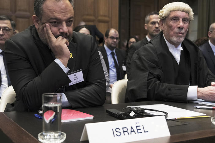 British jurist Malcolm Shaw, right, legal adviser to Israel's Foreign Ministry Tal Becker, left, look on during the opening of the hearings at the International Court of Justice in The Hague, Netherlands, Thursday, Jan. 11, 2024.