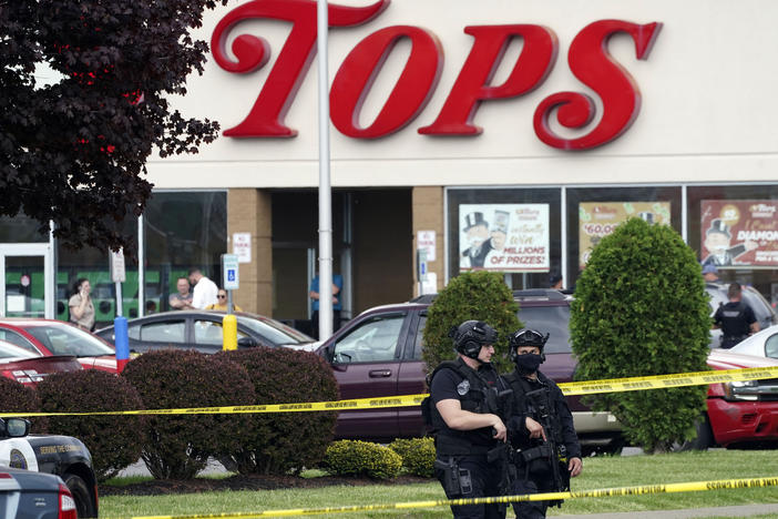 Police secure an area around a Buffalo, N.Y., supermarket where 10 people were killed in a shooting on May 14, 2022.
