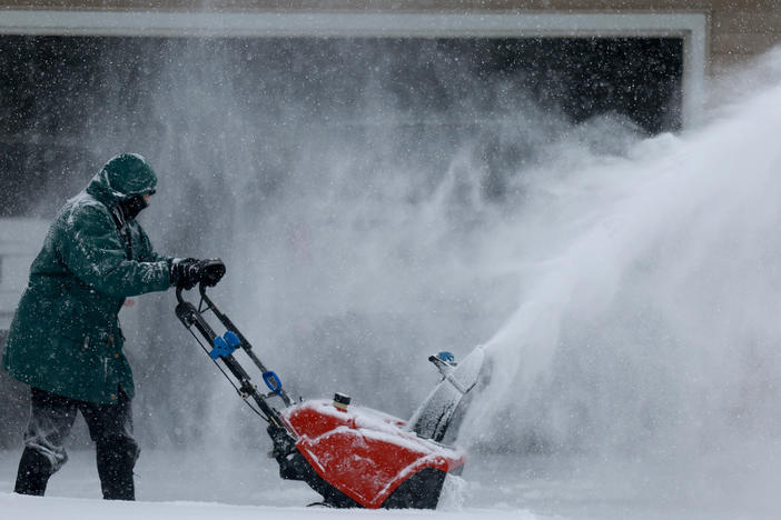 Linda Rae uses a snowblower to clear her driveway during a  snowstorm on Friday in Des Moines, Iowa.