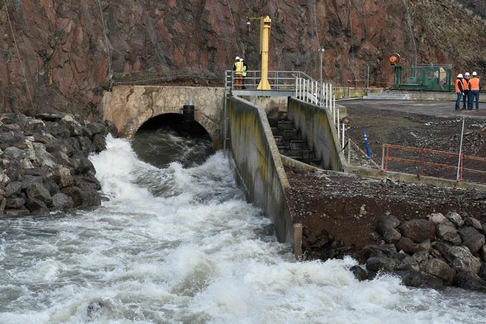 The bypass tunnel at the bottom of Iron Gate Dam in Northern California has been carefully reinforced so it can handle the load of water and sediment pouring through it.