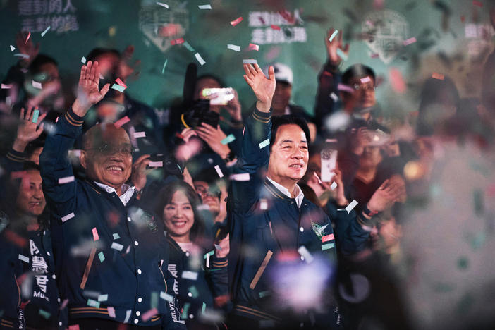 Lai Ching-te, Taiwan's president-elect (center) appears at an election night rally outside the Democratic Progressive Party headquarters in Taipei, Taiwan, on Saturday.