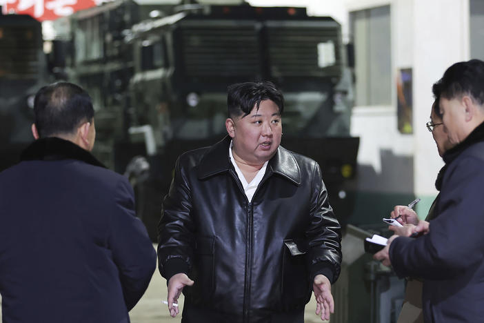 In this photo provided by the North Korean government, North Korean leader Kim Jong Un, center, inspects as he tours munitions factories in North Korea on Jan. 8-9, 2024.