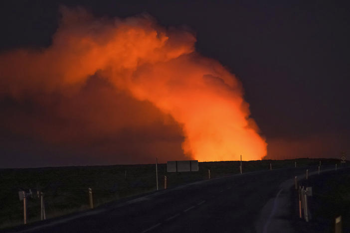 A view of the plume of gas lighted up by the lava from the erupting volcano seen from Suðurstrandavegur, the road that leads to Grindavík, Iceland, on Sunday.