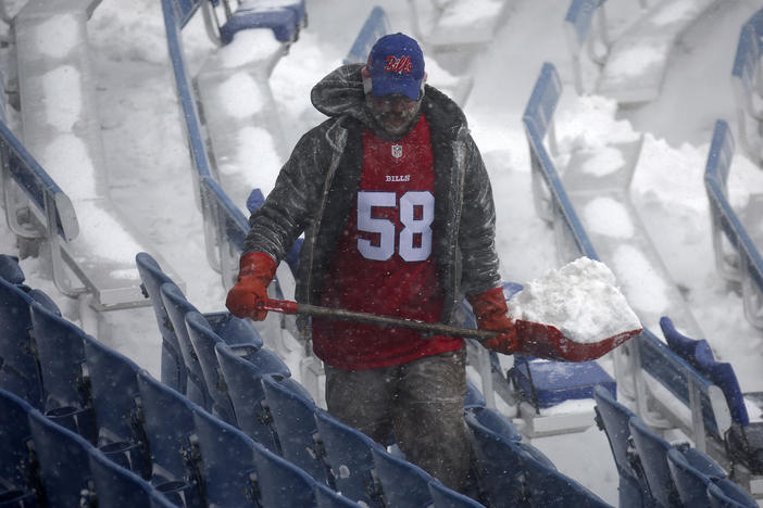 A worker helps remove snow from Highmark Stadium in Orchard Park, N.Y., Sunday Jan. 14, 2024. A potentially dangerous snowstorm that hit the Buffalo region on Saturday led the NFL to push back the Bills wild-card playoff game against the Pittsburgh Steelers from Sunday to Monday.
