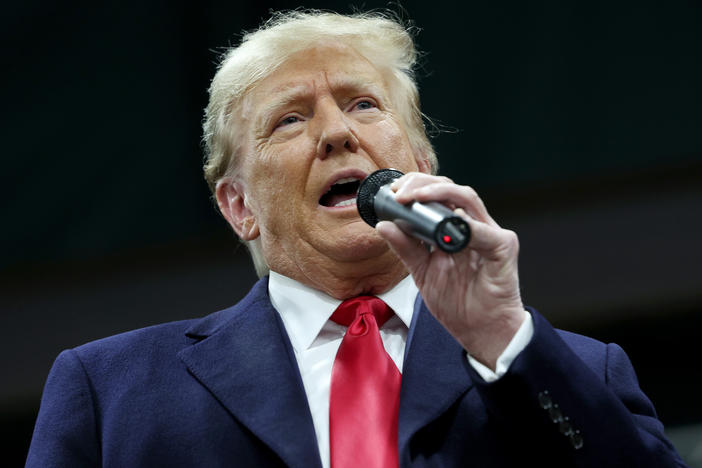 Former president Donald Trump speaks to voters during a visit to a caucus site at the Horizon Event Center on January 15, 2024 in Clive, Iowa.