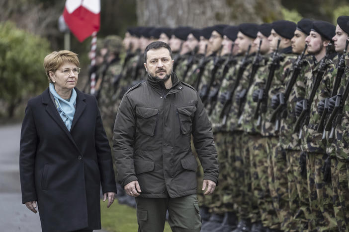 Swiss Federal President Viola Amherd, left, and her guest, Volodymyr Zelenskyy, right, President of Ukraine, inspect the guard of honour in Kehrsatz near Bern, Switzerland, Monday, Jan. 15, 2024.