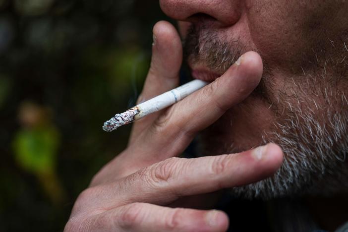 This picture taken on Oct. 31, 2023, shows a man smoking a cigarette in Sundbyberg, near Stockholm, Sweden. The WHO has issued a new report on global tobacco use, finding rates are going down.
