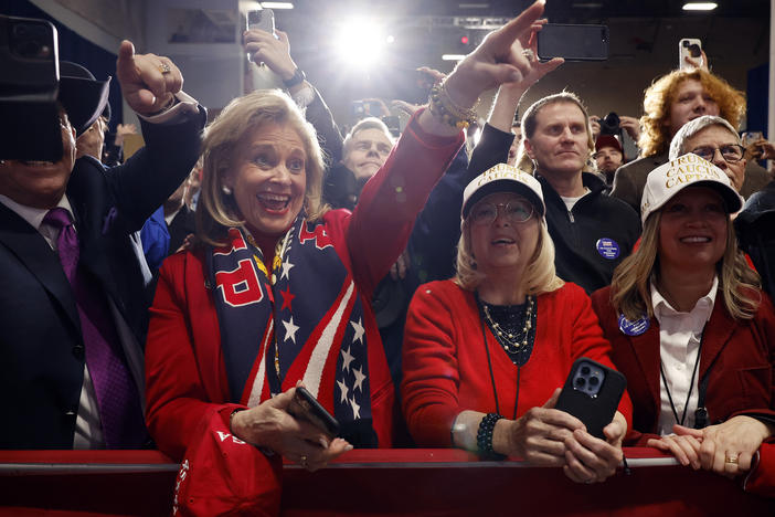 Supporters of former President Donald Trump cheer during his caucus night event in Des Moines, Iowa.