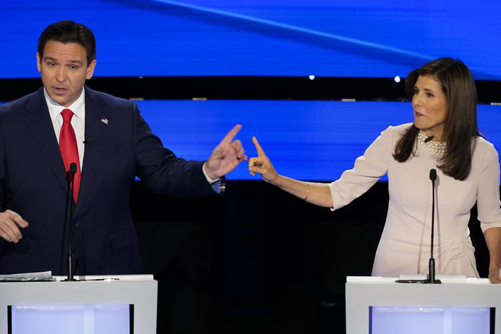 Former UN Ambassador Nikki Haley, right and Florida Gov. Ron DeSantis, left, pointing at each other during the CNN Republican presidential debate at Drake University in Des Moines, Iowa, Jan. 10, 2024.