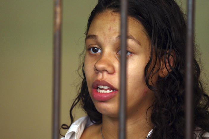 Heather Mack from Chicago, Ill., stands inside a cell before a trial in Bali, Indonesia, on March 11, 2015. Mack, who pleaded guilty to helping kill her own mother and stuffing the body in a suitcase during a luxury vacation in Bali, was sentenced by a federal judge, Wednesday to 26 years in prison.